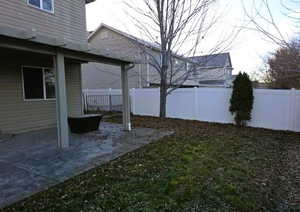 Fenced backyard with a patio area