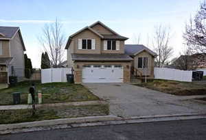 View of front of property with an attached garage and driveway