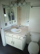 Bathroom featuring vanity and toilet