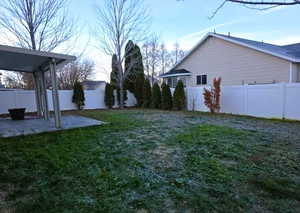 Fenced backyard with a patio area