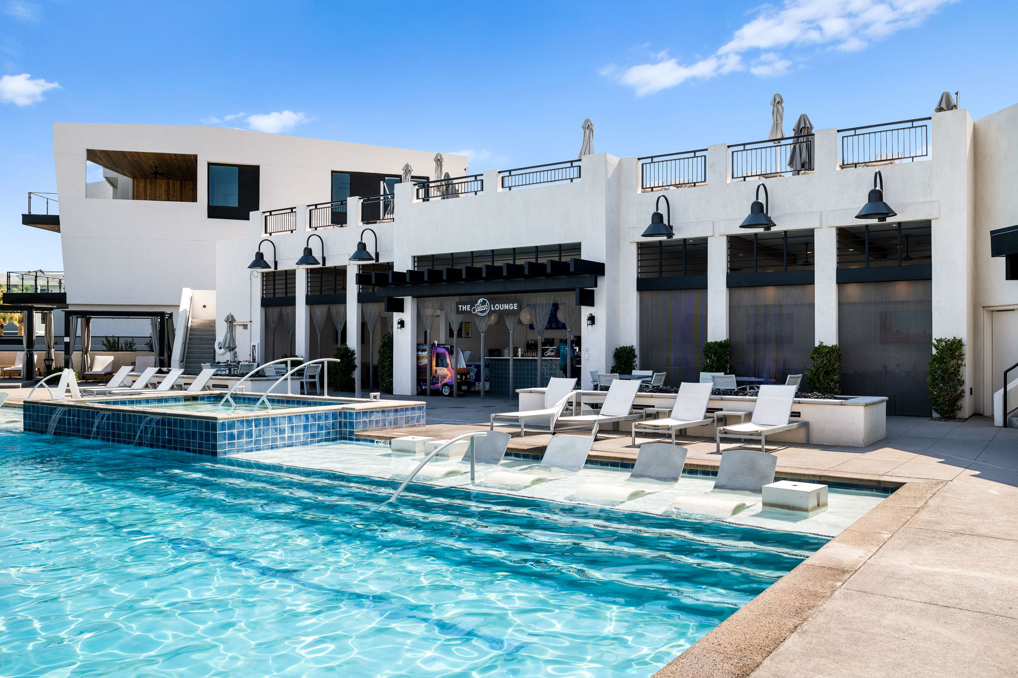 View of swimming pool featuring a patio and a pool with connected hot tub