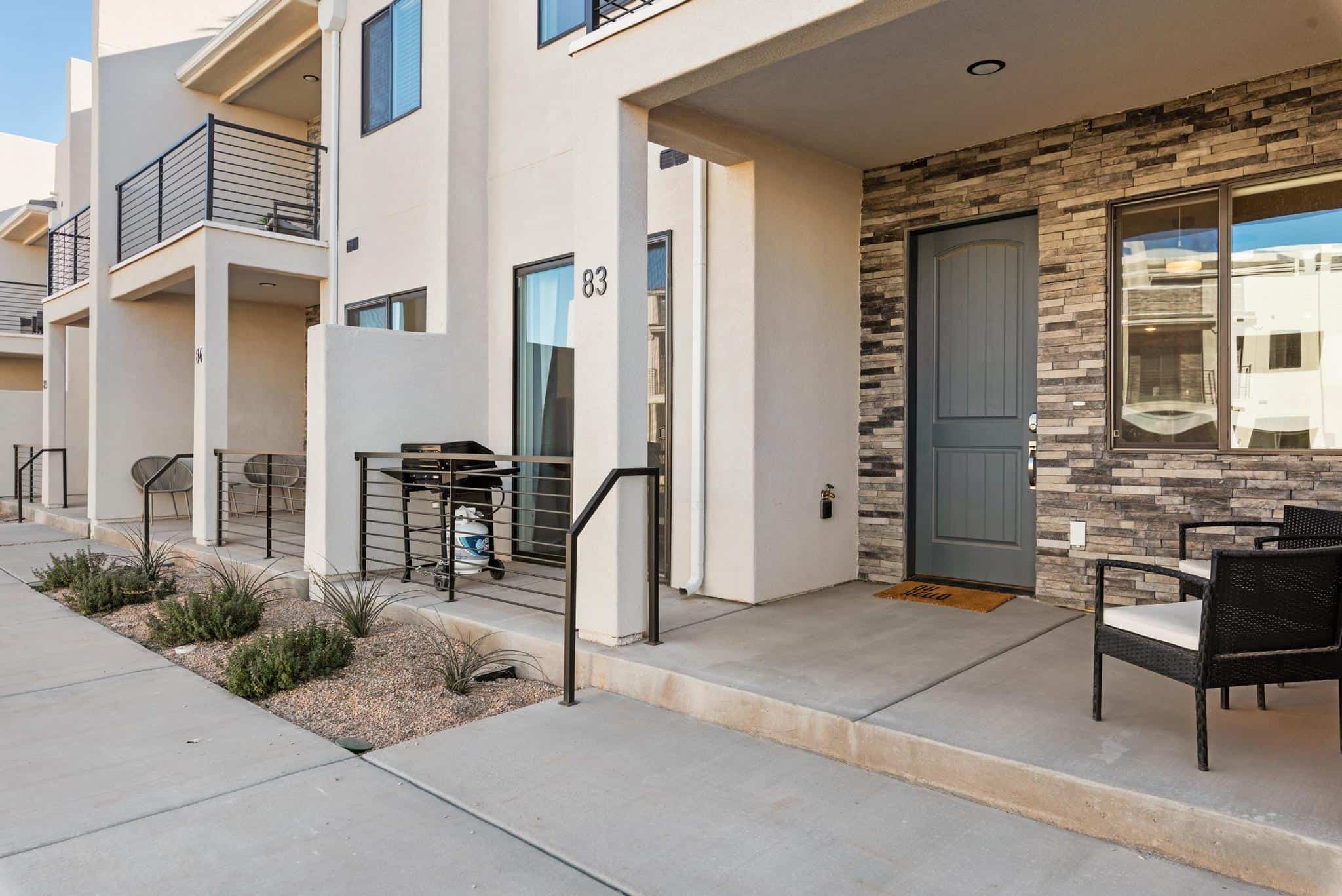 View of exterior entry with stone siding and stucco siding