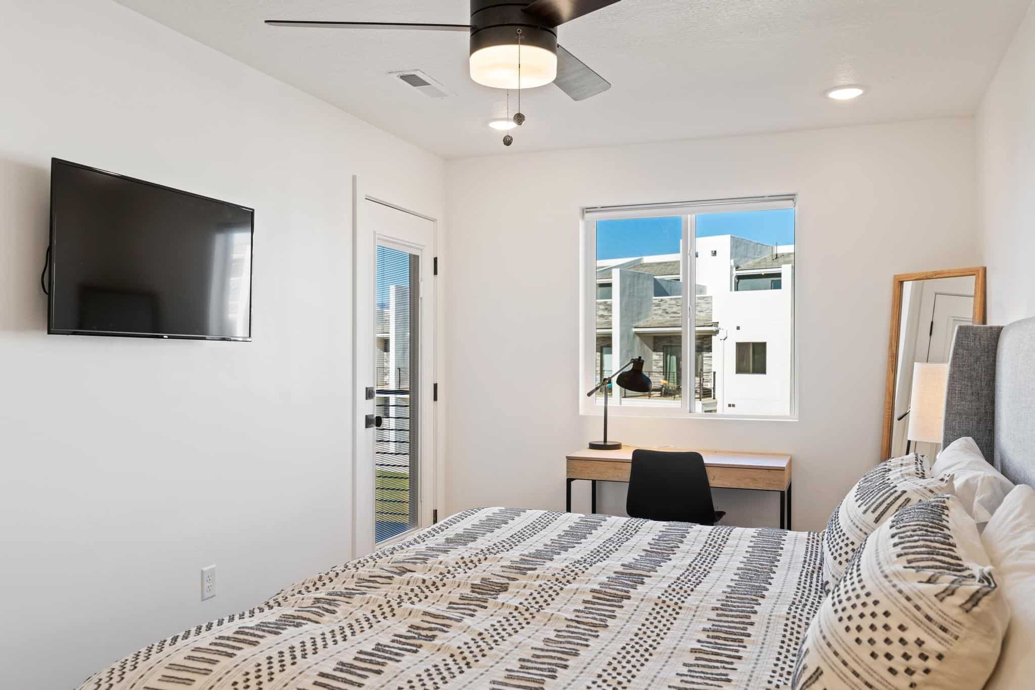 Bedroom featuring ceiling fan and access to exterior
