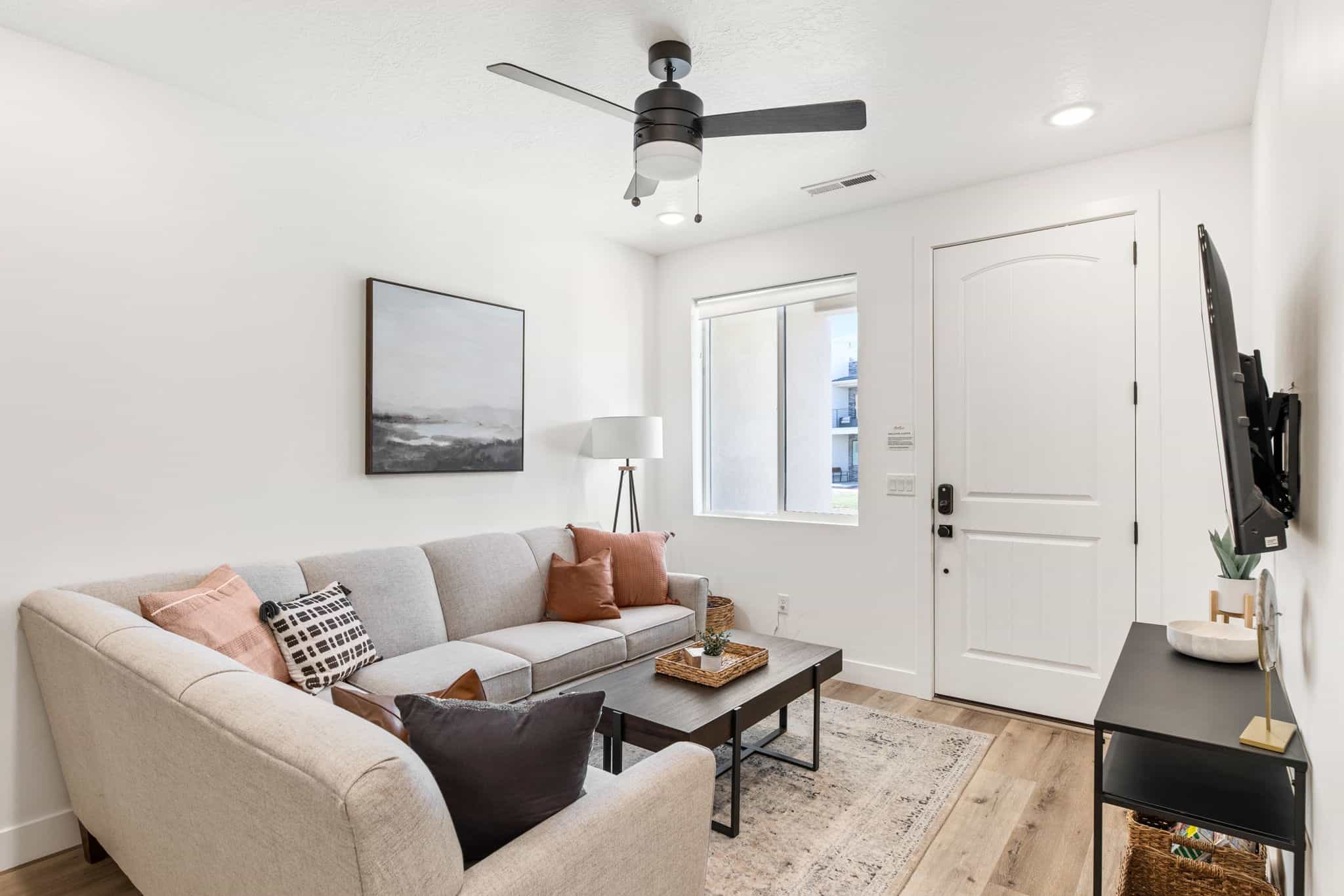 Living room with light wood-style floors, ceiling fan, and recessed lighting
