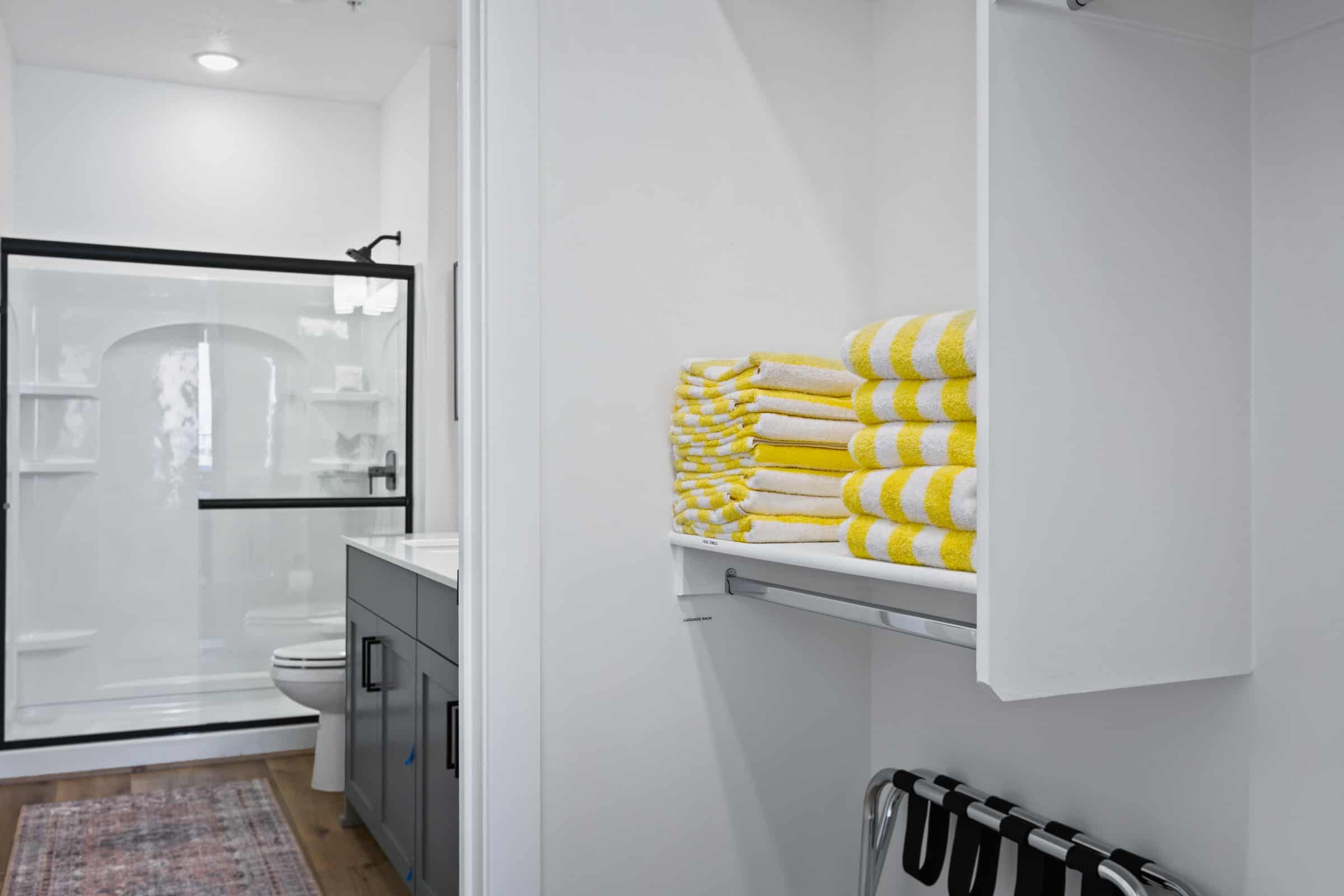 Bathroom with a shower stall, vanity, and dark wood-style flooring