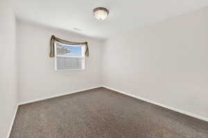 Unfurnished room featuring baseboards and carpet
