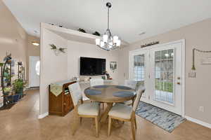 Dining space featuring a chandelier and lofted ceiling