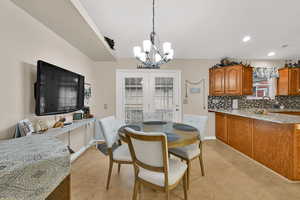 Dining room featuring french doors, a chandelier, and recessed lighting