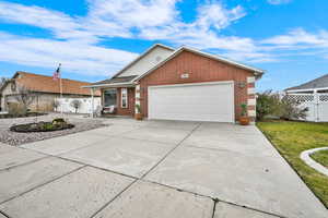 Ranch-style home with brick siding, driveway, and an attached garage