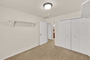 Unfurnished bedroom with carpet and a closet