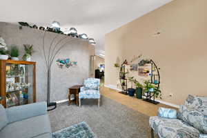 Carpeted living area with baseboards