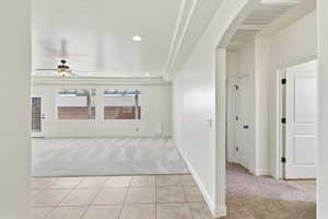 Open concept living area featuring recessed lighting, a ceiling fan, and large windows