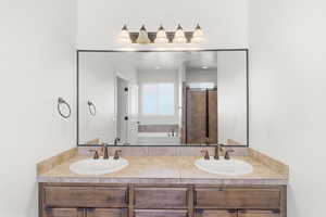 Dual vanity with wood-finish cabinetry and tiled countertops