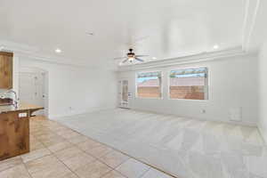 Spacious living area featuring light-toned carpeting and recessed lighting