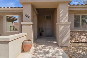 Inviting covered entry with a contemporary door and transom window