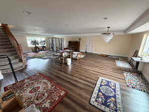 Living room featuring stairway and dark wood-type flooring