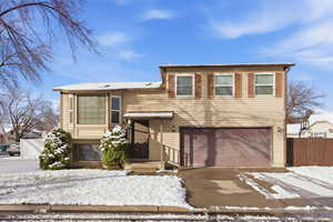 View of front of home with an attached garage and driveway