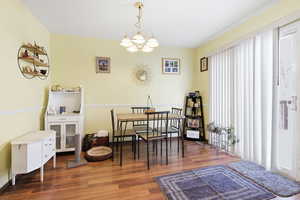 Dining space with a chandelier and wood finished floors
