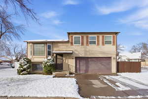 View of front of home featuring a garage and driveway