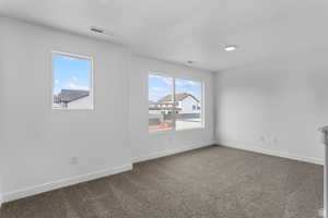 Unfurnished room featuring baseboards and carpet