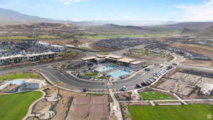 Aerial view of property's location featuring a pool area and a mountain backdrop