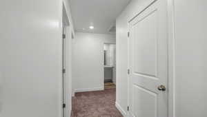 Hallway with carpet flooring and recessed lighting