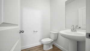 Bathroom featuring baseboards and wood finished floors