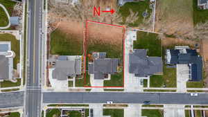 Aerial perspective of suburban area featuring property boundaries highlighted