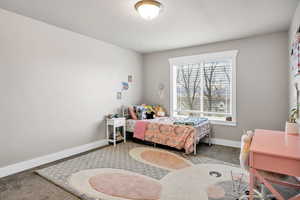 Carpeted bedroom featuring baseboards