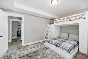 Bedroom featuring wood finished floors and baseboards