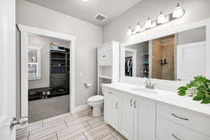 Ensuite Bathroom with a spacious closet and vanity