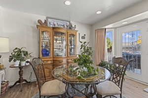 Dining space with wood finished floors, recessed lighting, and a textured ceiling