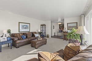 Carpeted living area with a chandelier