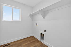 Washroom featuring dark wood finished floors, hookup for a washing machine, and hookup for an electric dryer