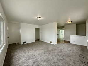 Carpeted living room featuring baseboards