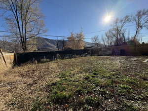 Fenced backyard featuring a mountain view