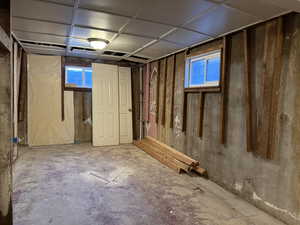 Unfinished basement bedroom  with panel ceiling