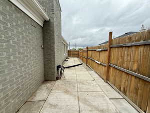 Fenced backyard featuring north side of house
