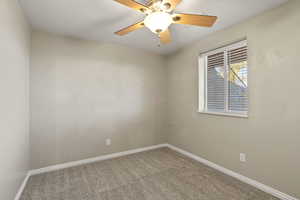Unfurnished room with carpet floors, a ceiling fan, and a textured ceiling