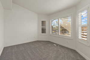 Empty room featuring carpet floors and baseboards