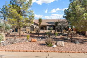View of front of home featuring a tiled roof and stone siding