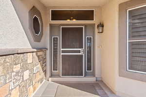 Entrance to property featuring stucco siding