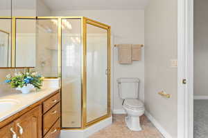 Full bath featuring vanity, a shower stall, and light tile patterned floors