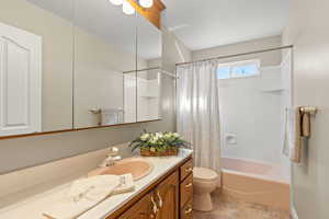 Bathroom with vanity and shower / tub combo