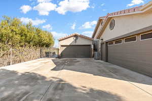 Garage featuring driveway and a gate