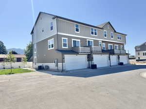View of front of house featuring board and batten siding, a garage, and driveway
