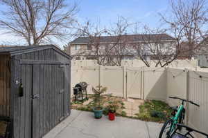 View of shed with a gate and a fenced backyard