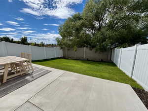 Fenced backyard featuring a patio area and outdoor dining area