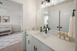 Bathroom featuring vanity and light colored carpet