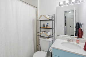 Full bath with a shower with shower curtain and vanity